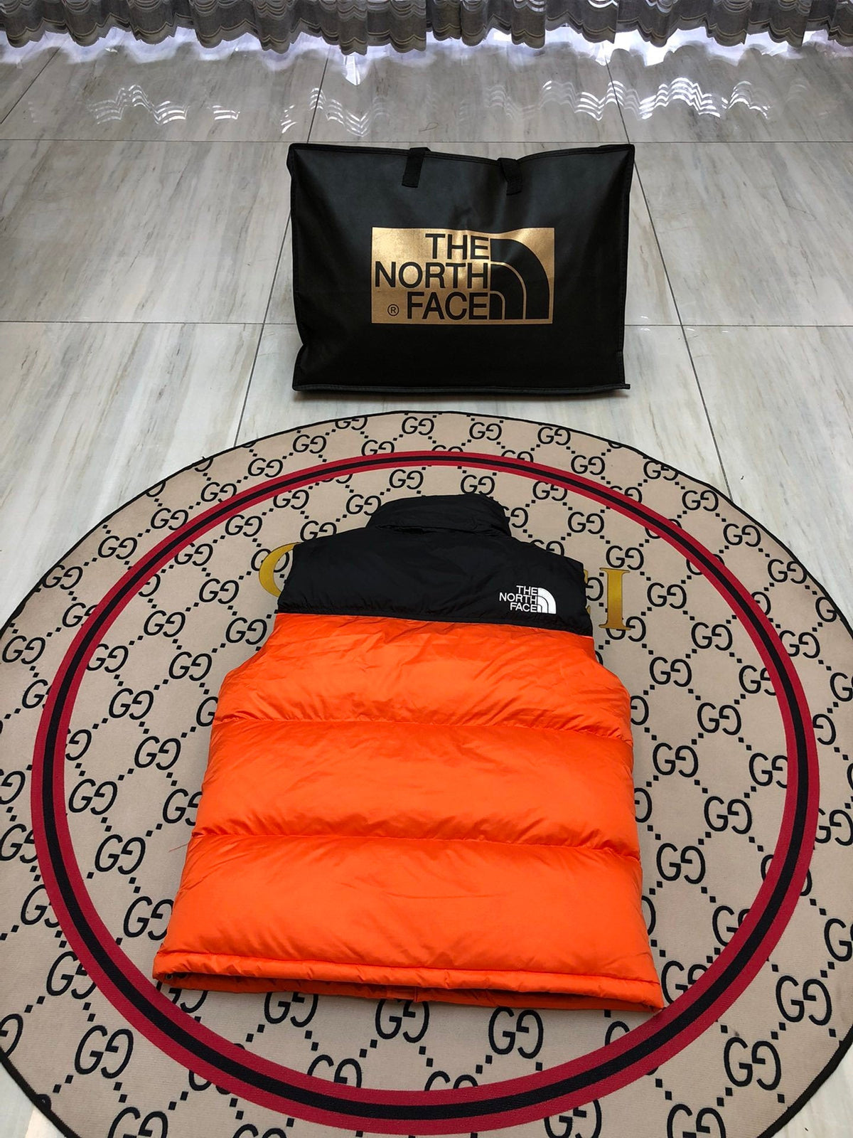 The North Face Puffer Vest in Orange and Black with Stand Collar